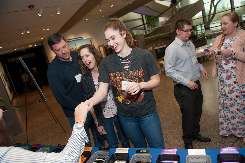 A student receiving their nametag an internship fair.