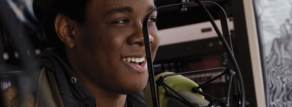 A student speaking into a radio microphone.