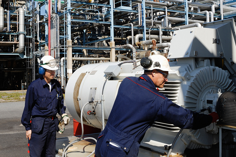 A group of technicians working on a generator.