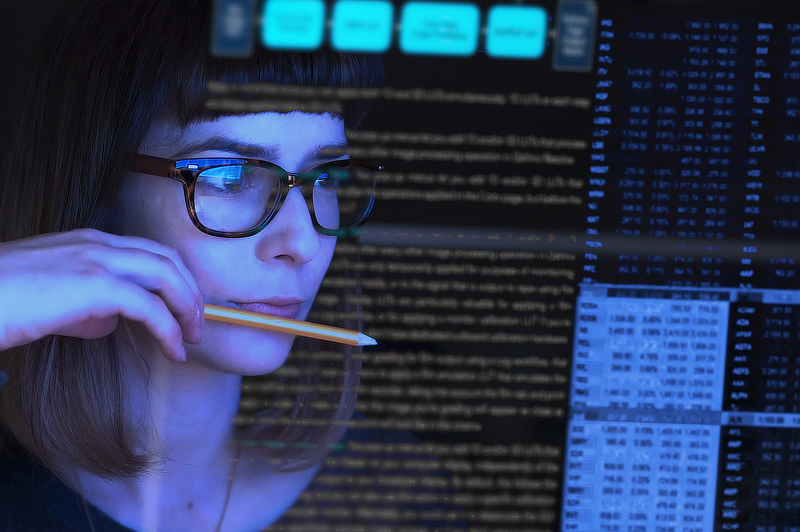 A technician evaluating data displayed before her.