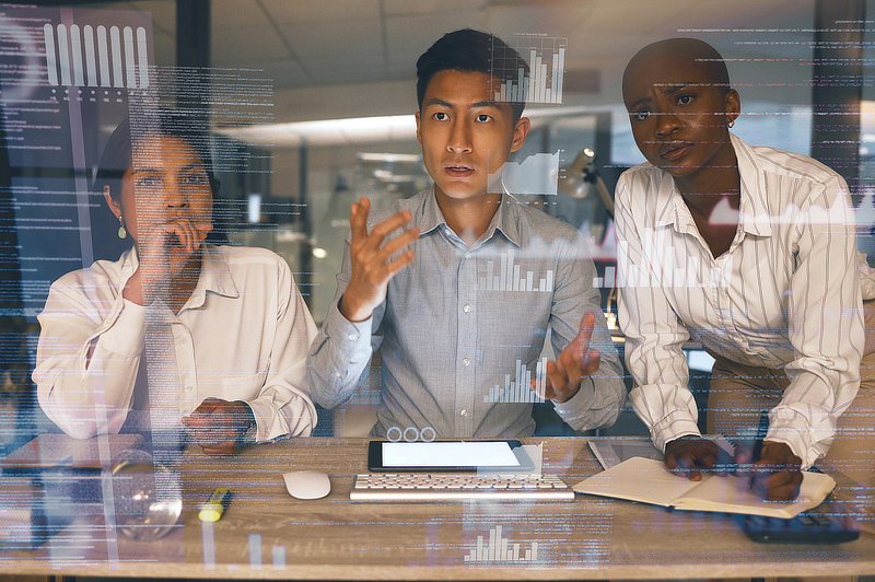 A group of analysts looking at a smartboard screen.